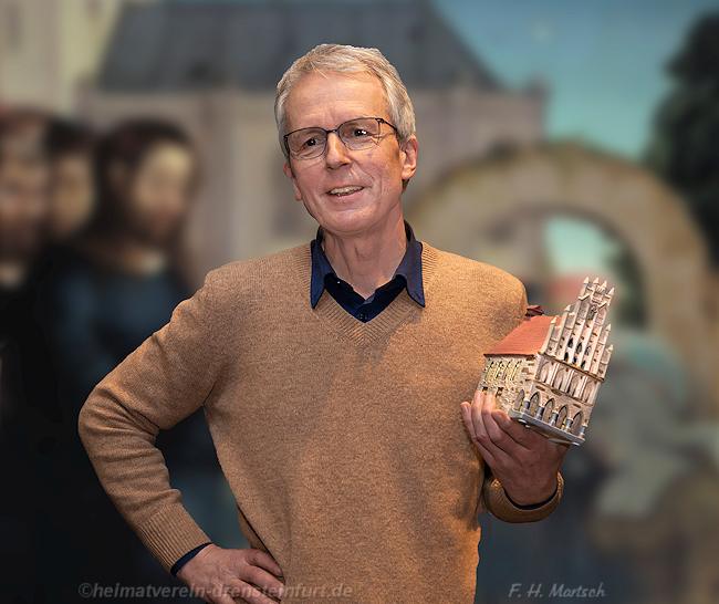 Die Abbildung (Foto: Holger Martsch) zeigt Dr. Klötzer, der zum Abschluss seines Vortrages als Geschenk vom Heimatverein ein Modell des Münsterschen Rathauses erhielt. img1